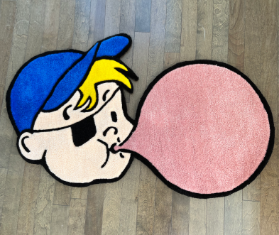 Thumbnail of a rug of Bazooka Joe character blowing a bubble with bubble gum
